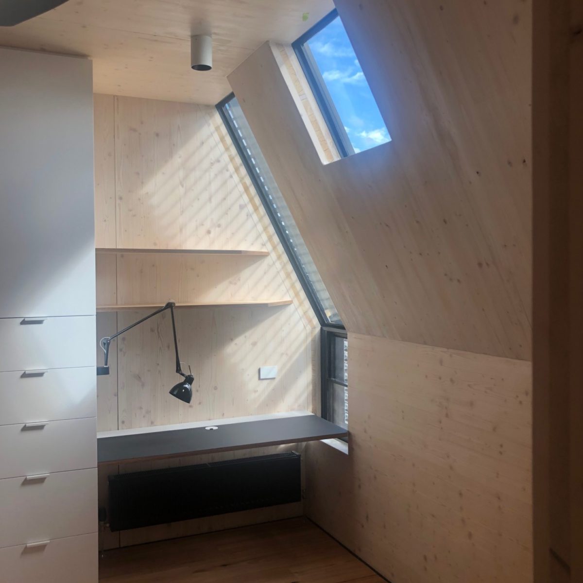 Union St CLT House Exposed timber office nook with desk, storage, and windows. In Union St CLT House.