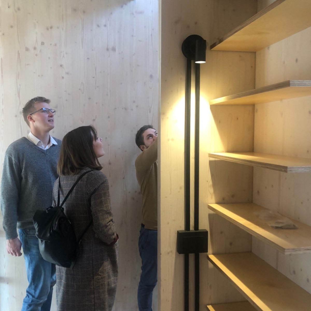 Union St CLT House Vistek Engineers looking at detail in Union St CLT House hallway, with exposed timber walls and shelves. At Union St CLT House.